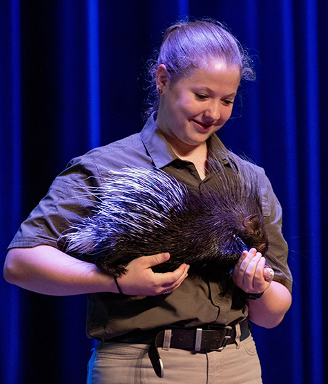 The Creature Teacher holding a porcupine