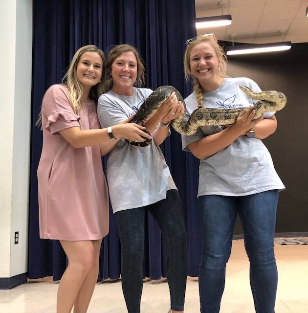 Teachers holding a snake