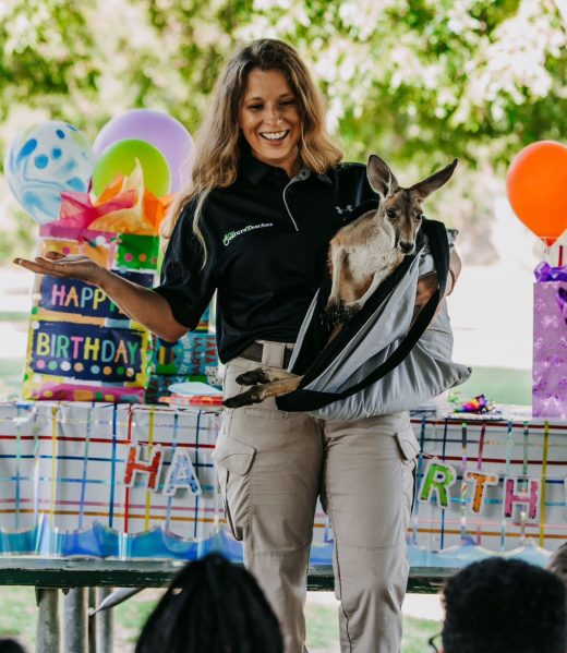 The Creature teacher holding a kangaroo at a live animal birthday party