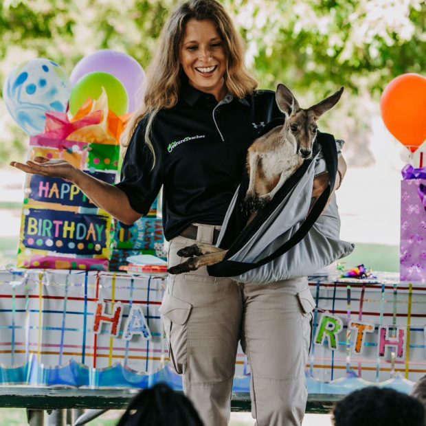 The Creature teacher holding a kangaroo at a live animal birthday party